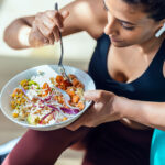 A woman eating healthy as part of her health diet to naturally lower high blood pressure.