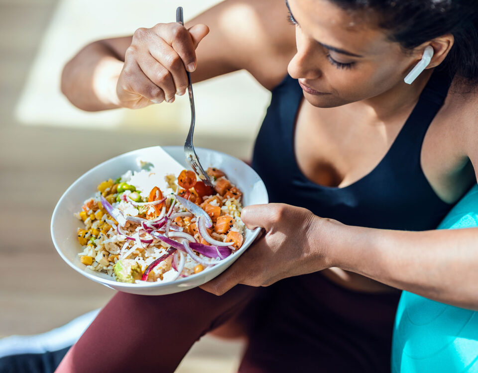 A woman eating healthy as part of her health diet to naturally lower high blood pressure.