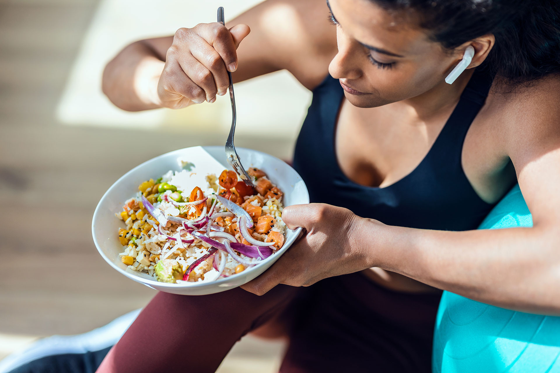 A woman eating healthy as part of her health diet to naturally lower high blood pressure.