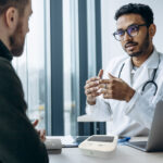 A doctor and patient discussing an arterial health assessment done using SphygmoCor technology.