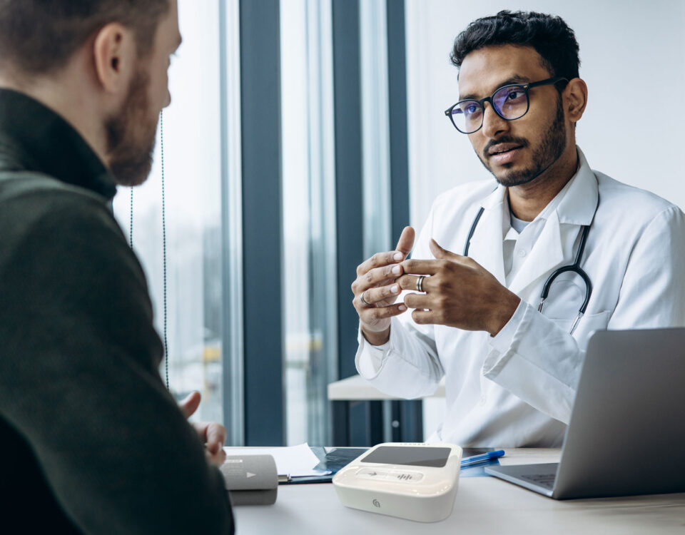 A doctor and patient discussing an arterial health assessment done using SphygmoCor technology.