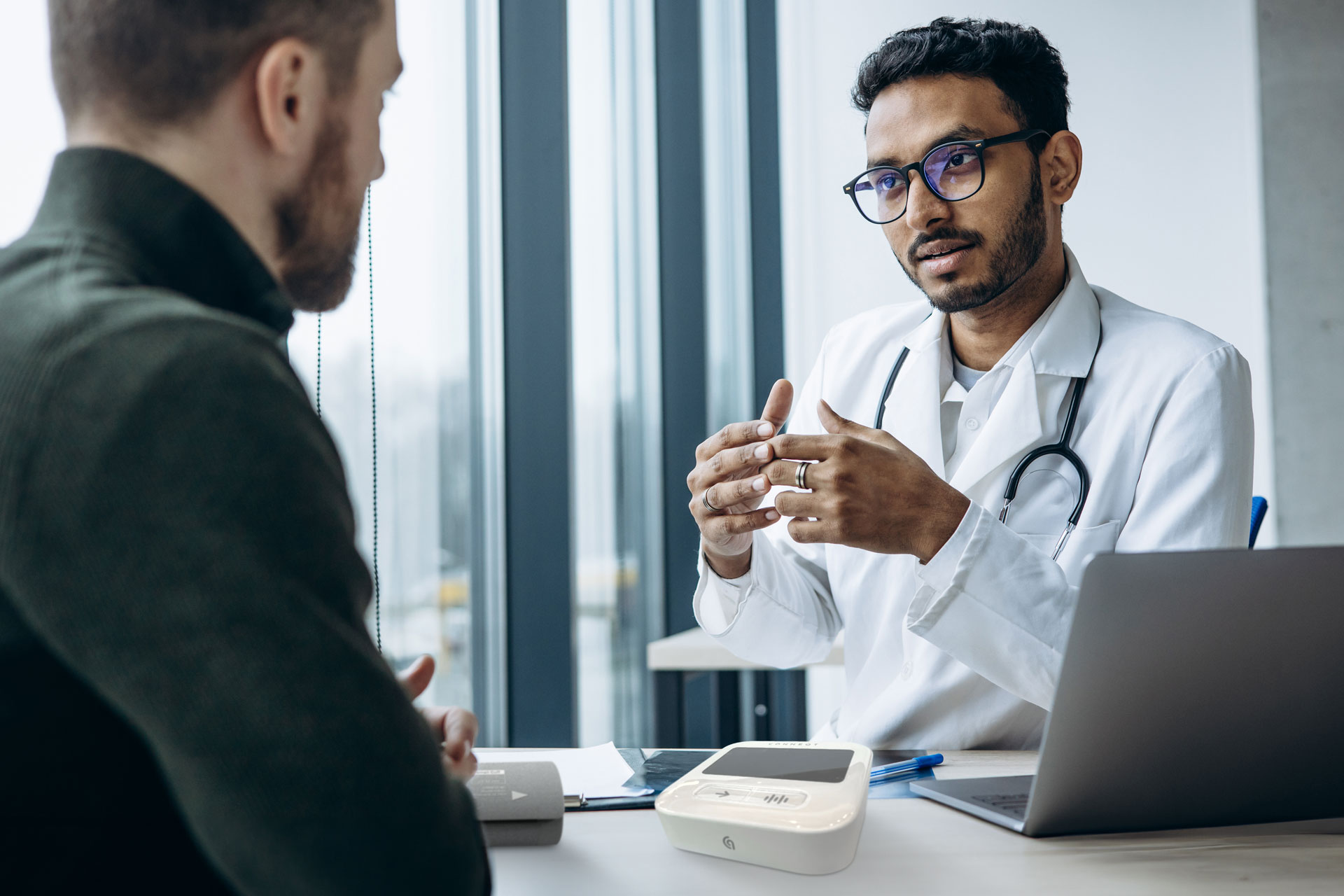 A doctor and patient discussing an arterial health assessment done using SphygmoCor technology.