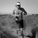 Craig running on a forest trail, reflecting on the cardiovascular risks of long-term endurance training and the importance of heart screening for athletes.