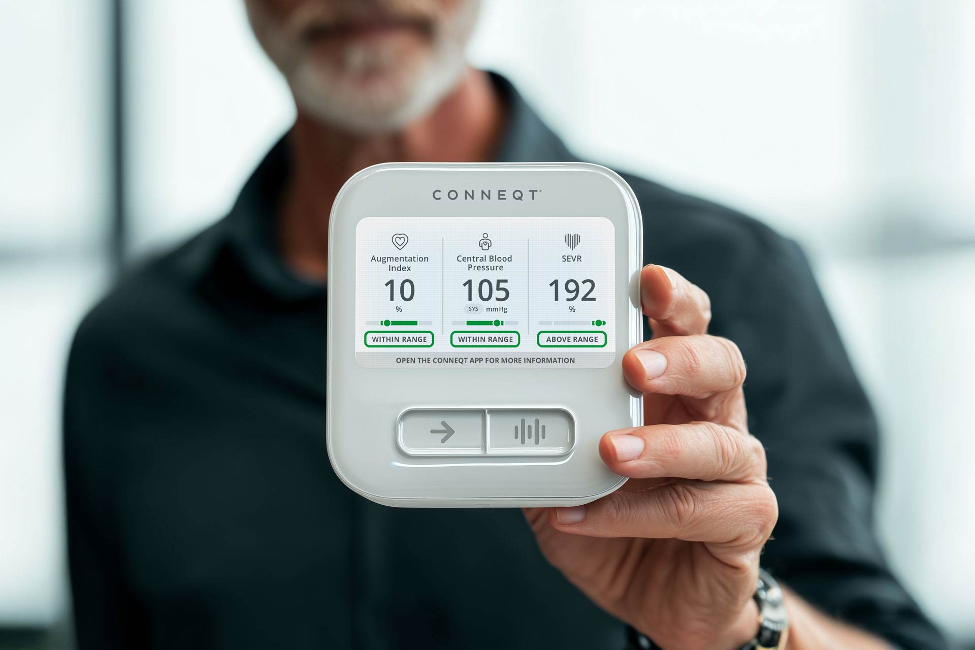 Close-up of the CONNEQT Pulse arterial health monitor showing central blood pressure and arterial health metrics during a reading.
