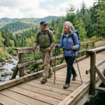 Fit couple walking across a bridge in the wood discussing what ai ApoB.