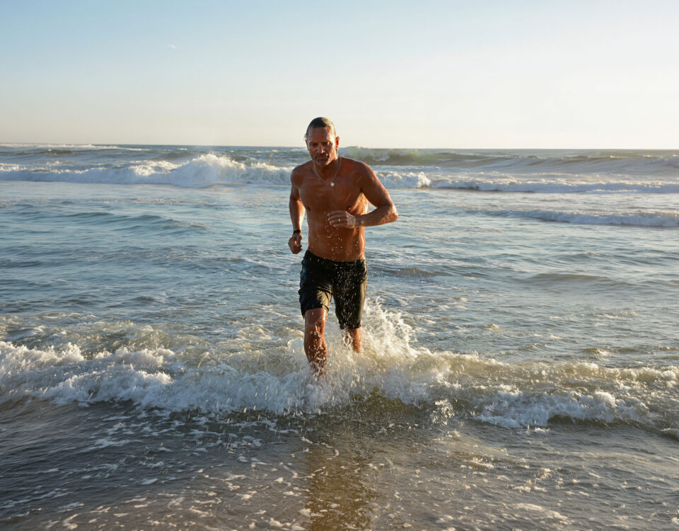 CONNEQT CEO Craig Cooper running out of the water thinking about fit athletes cardiovascular risk.