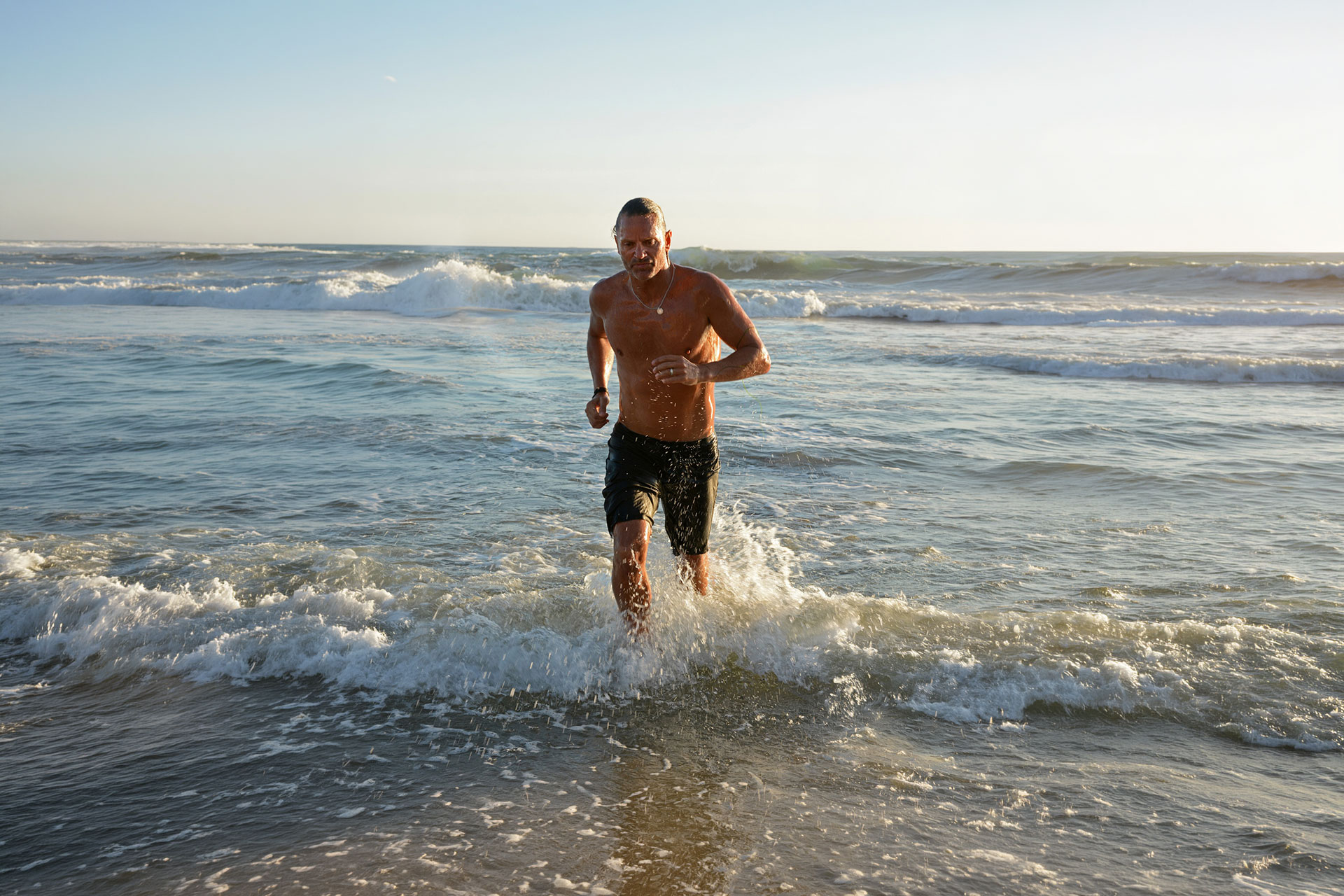 CONNEQT CEO Craig Cooper running out of the water thinking about fit athletes cardiovascular risk.