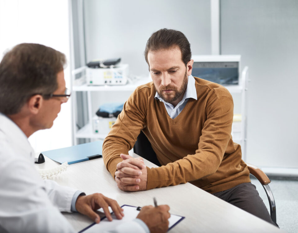 A man meeting with his doctor and considering blood pressure and dementia