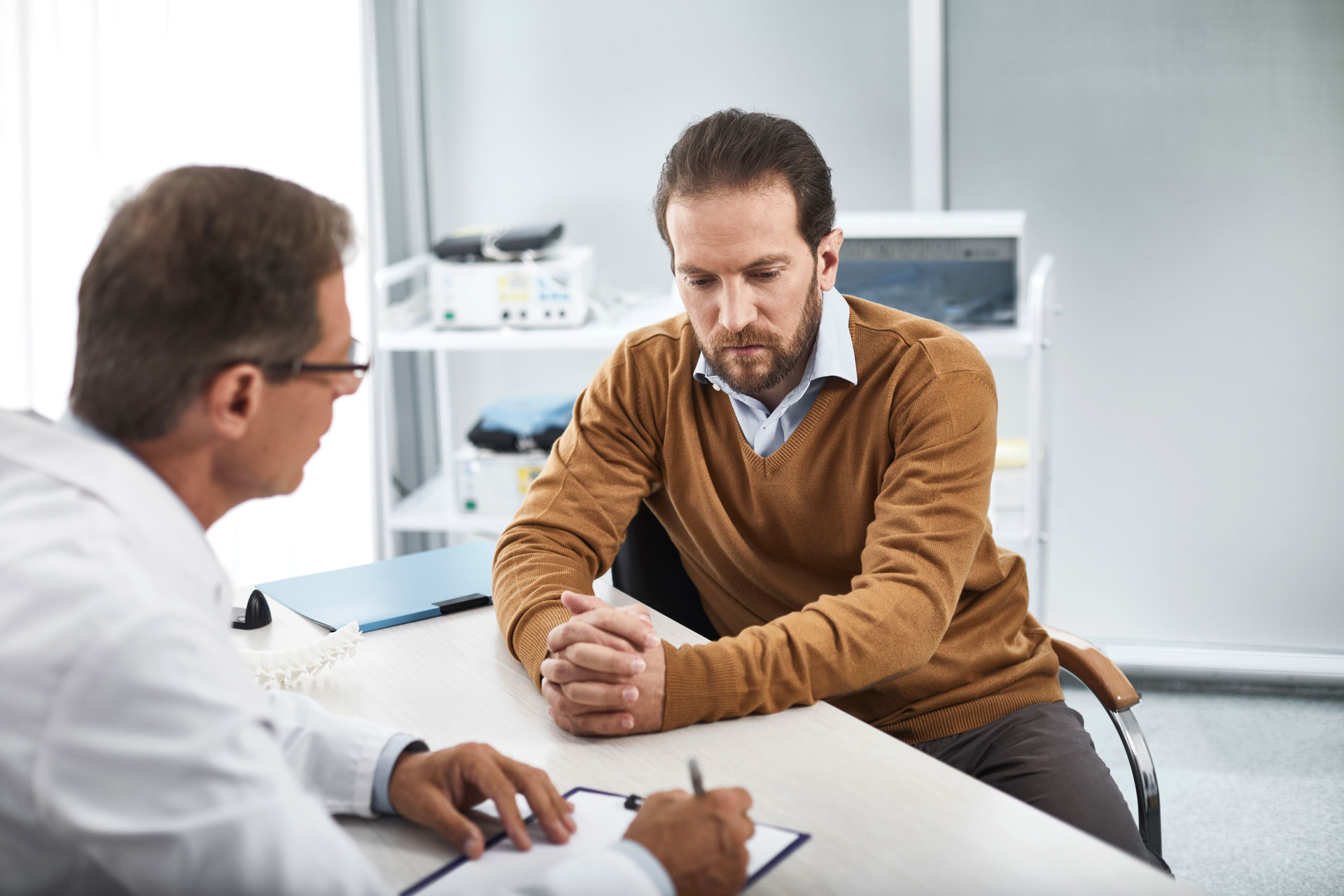 A man meeting with his doctor and considering blood pressure and dementia