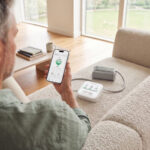 A man looking at his CONNEQT app thinking about home blood pressure monitor accuracy