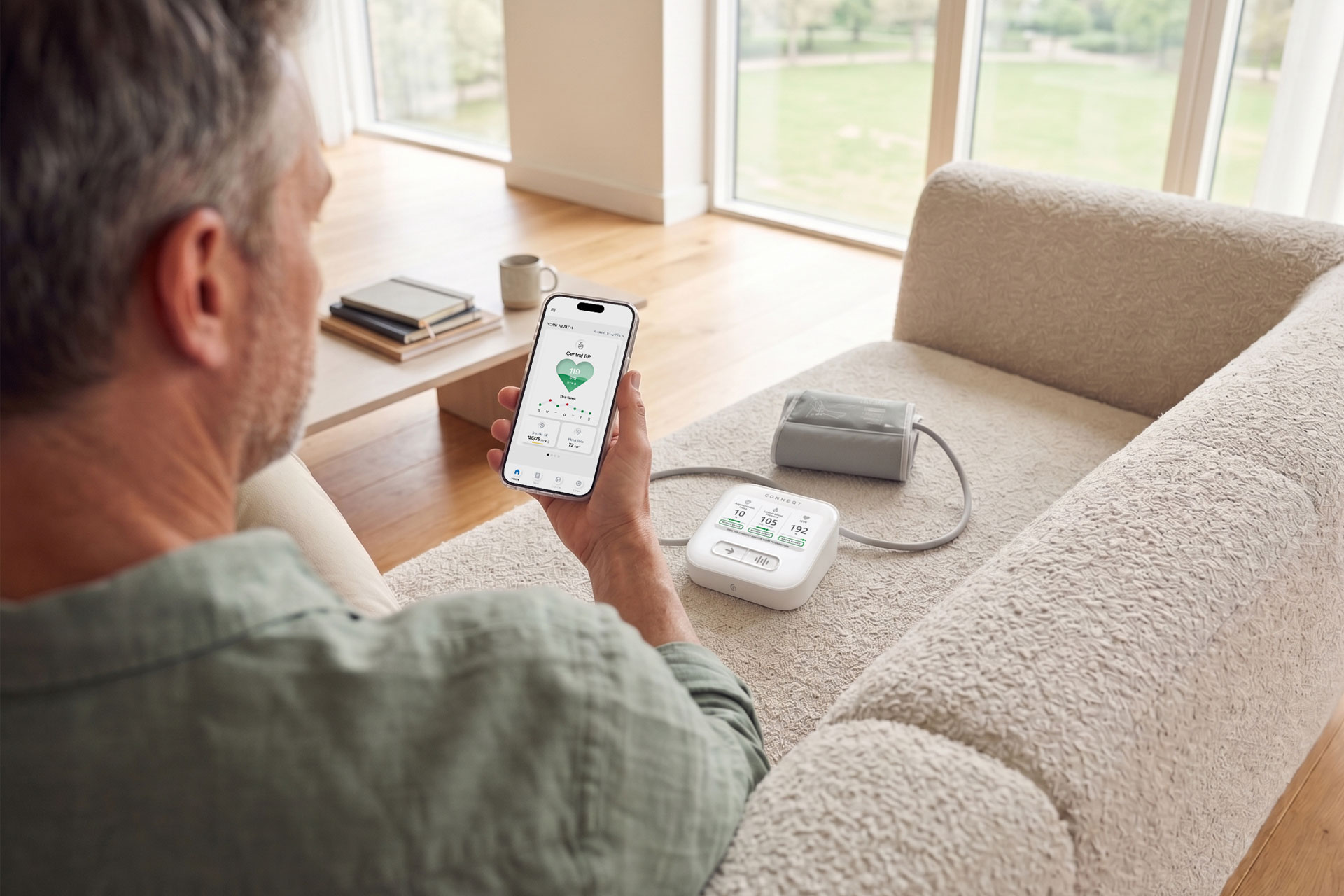 A man looking at his CONNEQT app thinking about home blood pressure monitor accuracy