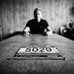 A man sitting at a table thinking about his marathon training weight gain.