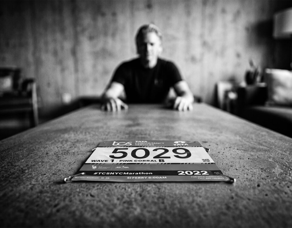 A man sitting at a table thinking about his marathon training weight gain.