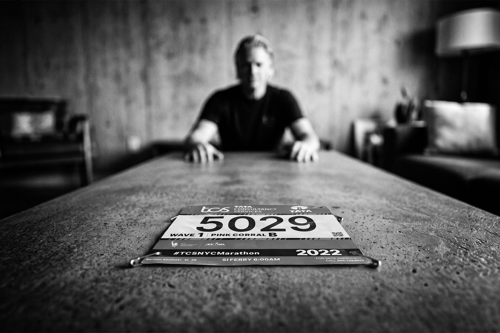 A man sitting at a table thinking about his marathon training weight gain.