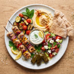 A plate sitting on a wooden table showing what to eat for heart health.