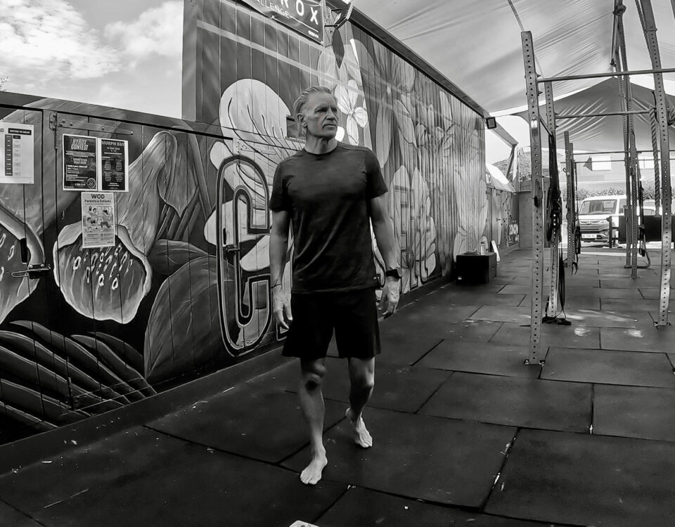 Craig Cooper, lean and fit at 63, walks barefoot through an open-air gym, the setting behind his account of how he lowered his ApoB.
