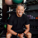 Craig Cooper, lean and fit at 63, walks barefoot through an open-air gym, the setting behind his account of how he lowered his ApoB.