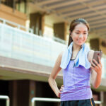 Woman checking her heart rate score on her phone following some exercise.