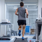 An athlete measuring his arterial health while running on a treadmill.